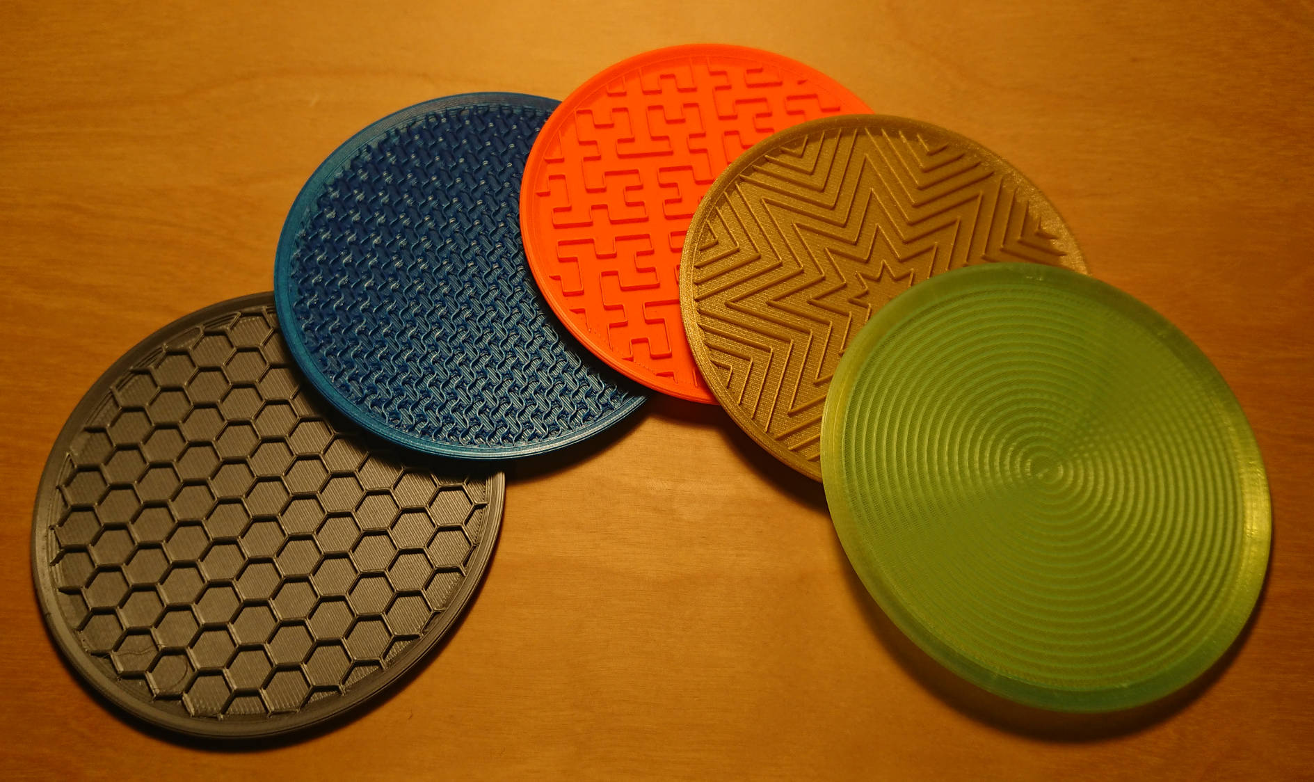 Five infill coasters, printed with different materials and patterns